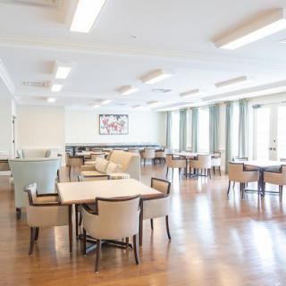 A spacious and modern dining area with wooden floors and contemporary furniture.