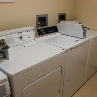 A laundry room featuring a washing machine and dryer side by side.