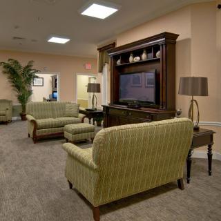 A cozy living room with sofas, chairs, a television, and elegant decor.