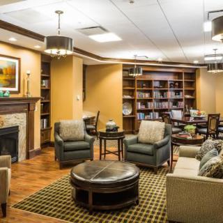 A cozy lounge area with comfortable seating and a fireplace.