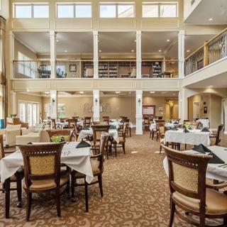 A spacious and elegant dining area with neatly arranged tables and chairs.