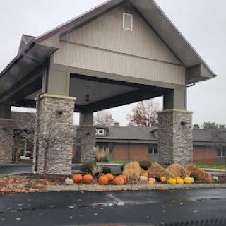 A welcoming entrance adorned with pumpkins and hay bales, showcasing the beauty of autumn.