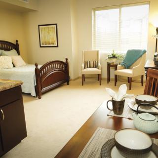 A cozy bedroom with classic furniture and soft natural lighting.