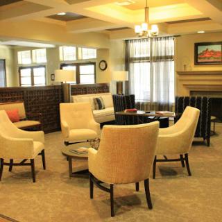 A cozy and inviting living room interior featuring comfortable seating and warm lighting.