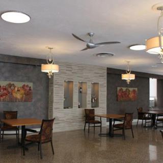 A stylish and modern dining area featuring contemporary furniture and ambient lighting.