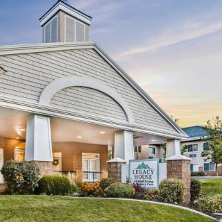 A modern residential building with an elegant entrance and well-maintained landscaping.