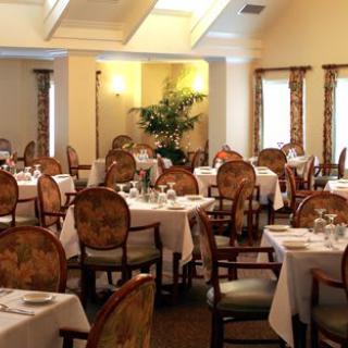A beautifully arranged dining room with elegantly set tables and chairs.