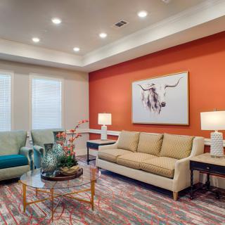 A modern living room with colorful accents and contemporary furniture.