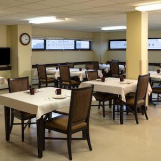 An empty dining room with neatly arranged tables and chairs.