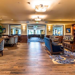 A spacious lounge area with elegant furniture and warm lighting.