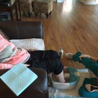 A person enjoys a soothing foot bath at home.