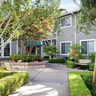 A charming residential area with a well-maintained garden and pathway.