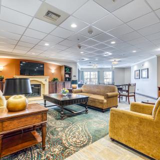 A spacious and well-lit living room with comfortable seating and a cozy atmosphere.