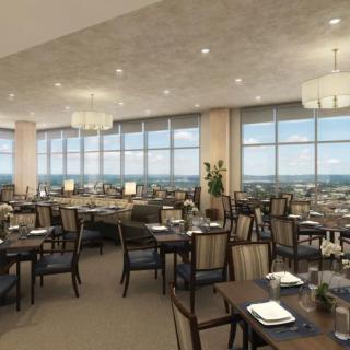 An elegant dining area with large windows offering a panoramic city view.