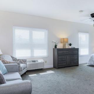 A bright and spacious living room with modern furnishings and ample natural light.