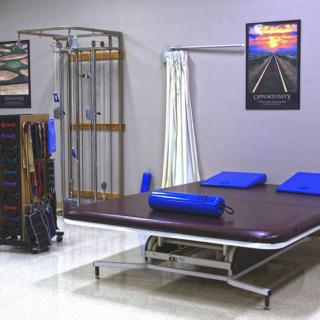A physiotherapy room equipped with a therapy table and exercise equipment.