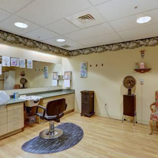 A well-appointed hair salon interior featuring a vanity, comfortable chair, and decorative elements.