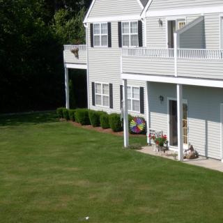 A residential house with a neatly maintained lawn and garden.
