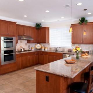 A modern kitchen with wooden cabinets, stainless steel appliances, and a central island.