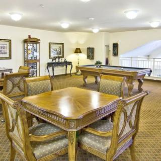 A classic and elegant lounge area featuring a wooden table and chairs.