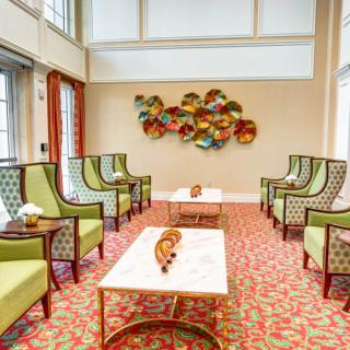 A modern lounge featuring stylish seating and vibrant wall art.