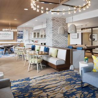 Modern hotel lounge area with comfortable seating and stylish chandeliers.