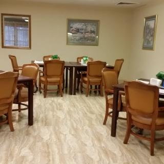 A neatly arranged dining area with multiple tables and chairs.