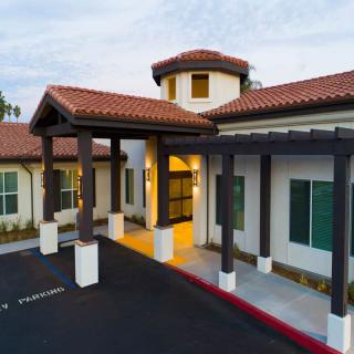A modern building with a tiled roof and spacious entrance.