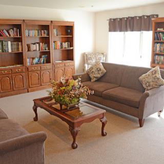 A cozy living room featuring elegant furniture and bookshelves.