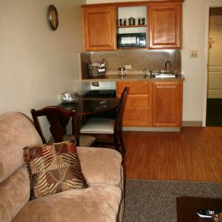 Cozy apartment living area with a small kitchenette and dining space.