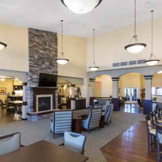 A spacious and modern lounge area with a fireplace and ample seating.