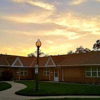 A serene sunset illuminating a charming residential building.