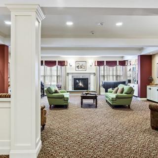 Spacious living room with comfortable seating and a central fireplace.