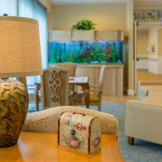 A cozy living room with an aquarium and decorative elements.