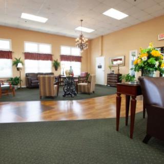 A spacious and well-lit lobby with comfortable seating, decorative plants, and a welcoming atmosphere.
