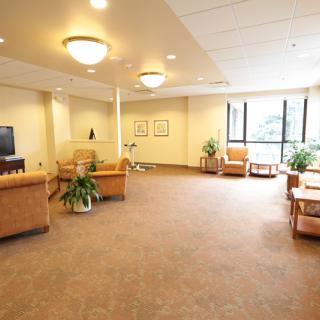 A spacious and well-lit lobby area with comfortable seating and large windows.
