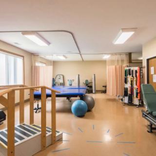 A well-equipped rehabilitation and therapy room with various exercise tools and equipment.