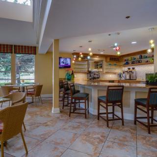 A cozy bar area with high chairs and ambient lighting.