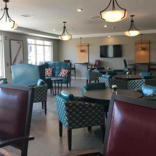 A modern lounge area featuring comfortable seating with elegant lighting.