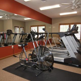 A well-equipped gym featuring treadmills and a stationary bike, perfect for indoor workouts.