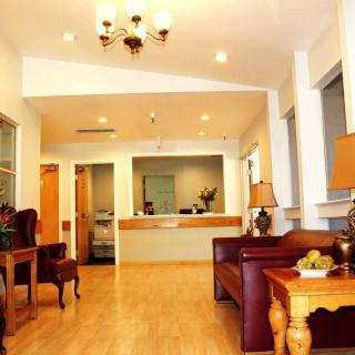 A cozy office reception area with comfortable seating and elegant lighting.