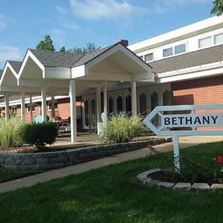 Entrance to a residential facility named Bethany, featuring well-maintained landscaping and a welcoming facade.