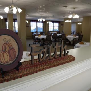 A cozy dining area featuring elegant decor with a focus on the theme of 'Faith'.