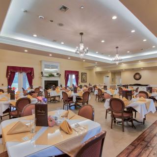 Elegant dining room with neatly arranged tables and warm lighting.