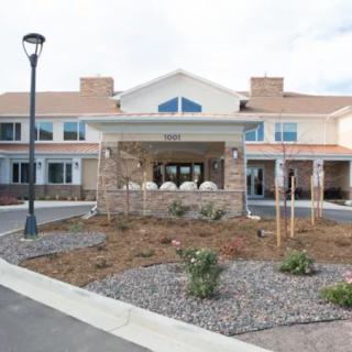 A modern residential building with a landscaped entrance.