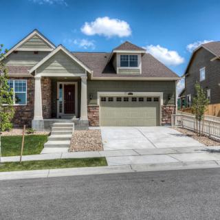 A suburban house with a garage and a well-maintained lawn.