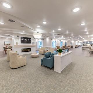 A spacious and modern lounge area with ample seating and warm lighting.