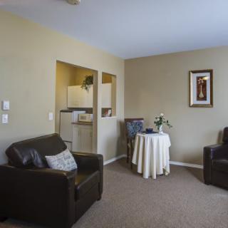 A cozy living room with comfortable seating and a small dining area.