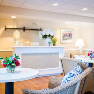 A cozy lounge area with comfortable seating and floral decorations.