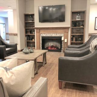 A cozy living room with a fireplace, television, and comfortable seating.
